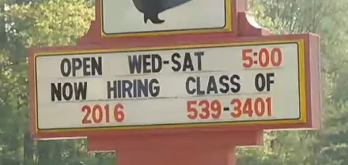 Closeup shot of the strip club's sign encouraging recent high school graduates to come work for them, Photo Credit: SanVic