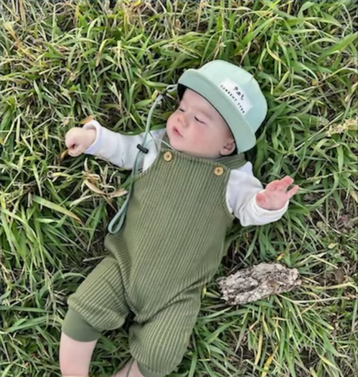 Toddler Zeke Best laying in some grass, Photo Credit: ABC4 Utah/Youtube