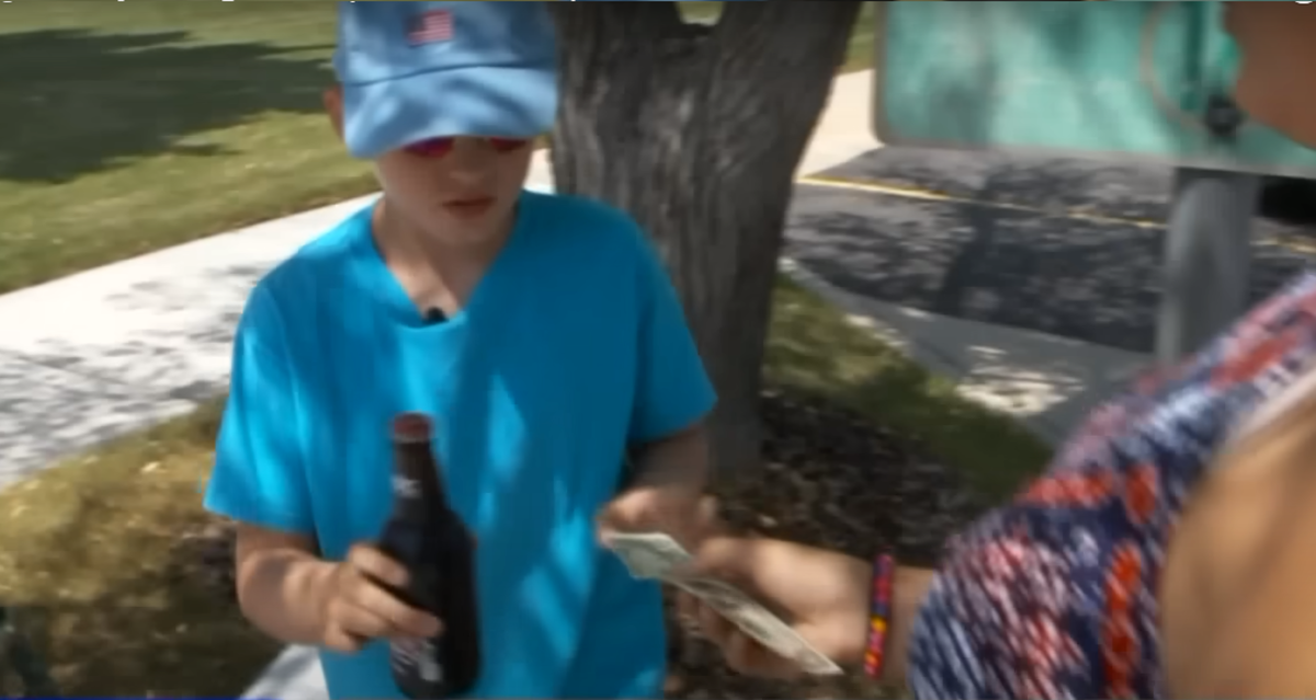 Seth Parker receiving money from a customer for his root beer, Photo Credit: FOX 13 News Utah/Youtube