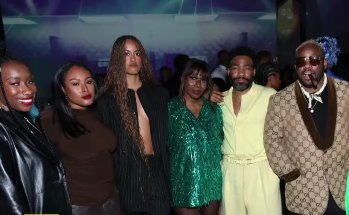 Malia Ann, formerly known as Malia Obama, posing with Childish Gambino and others at an event, Photo Credit: Entertainment Tonight/Youtube