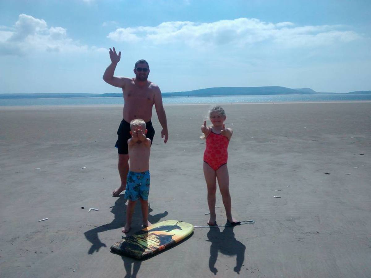 Gareth Gravell with his children on the beach, Photo Credit: Gareth Gravell/Facebook