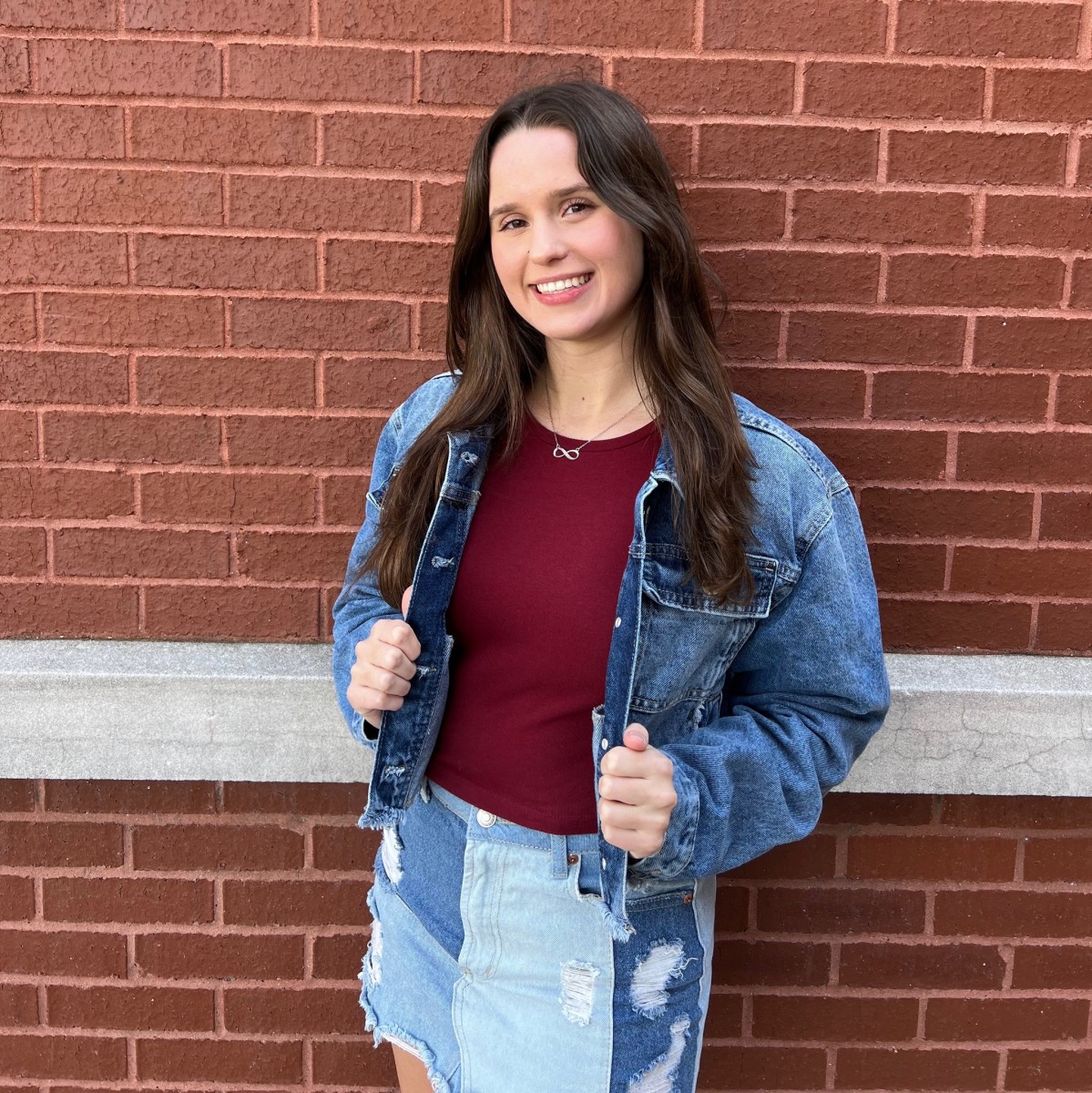 Avery Koonce posing for the camera in front of a brick wall, Photo Credit: Avery Koonce/Facebook