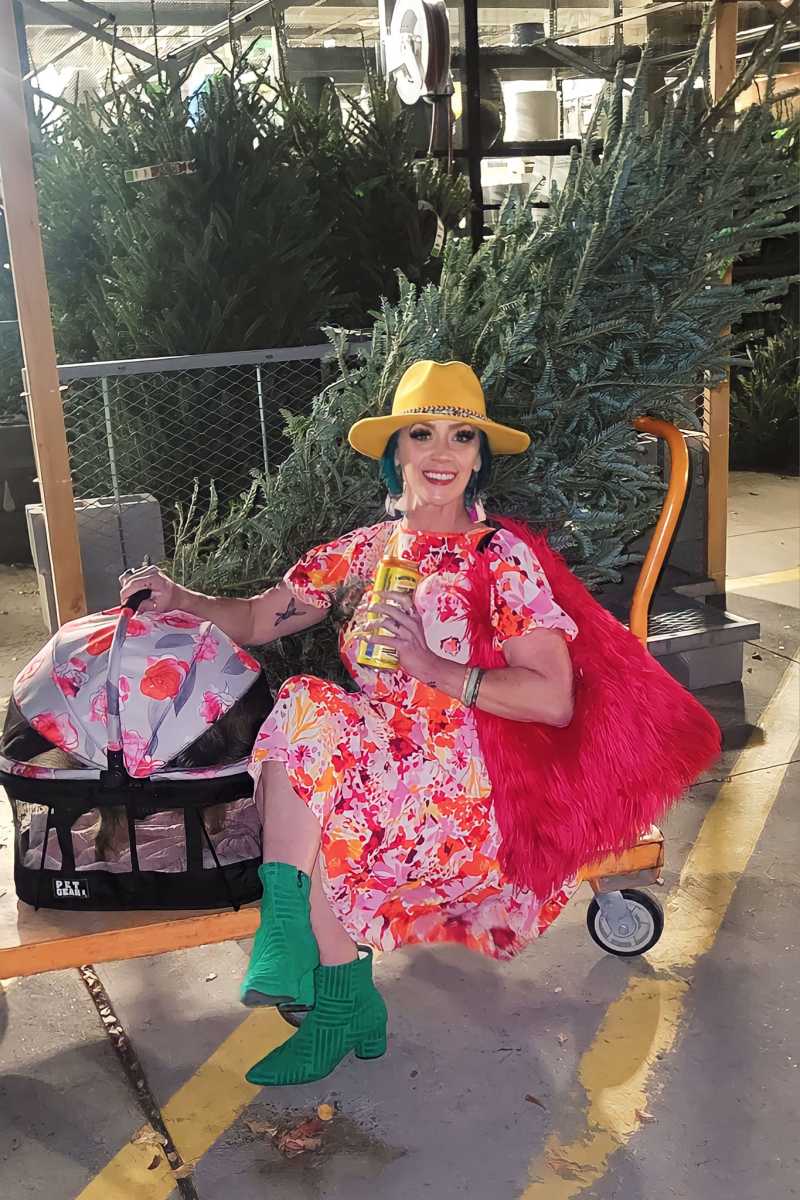 Brandalyn Mae Porter posing while sitting with Christmas trees for sale in the background, Photo Credit: Brandalyn Mae Porter/Facebook