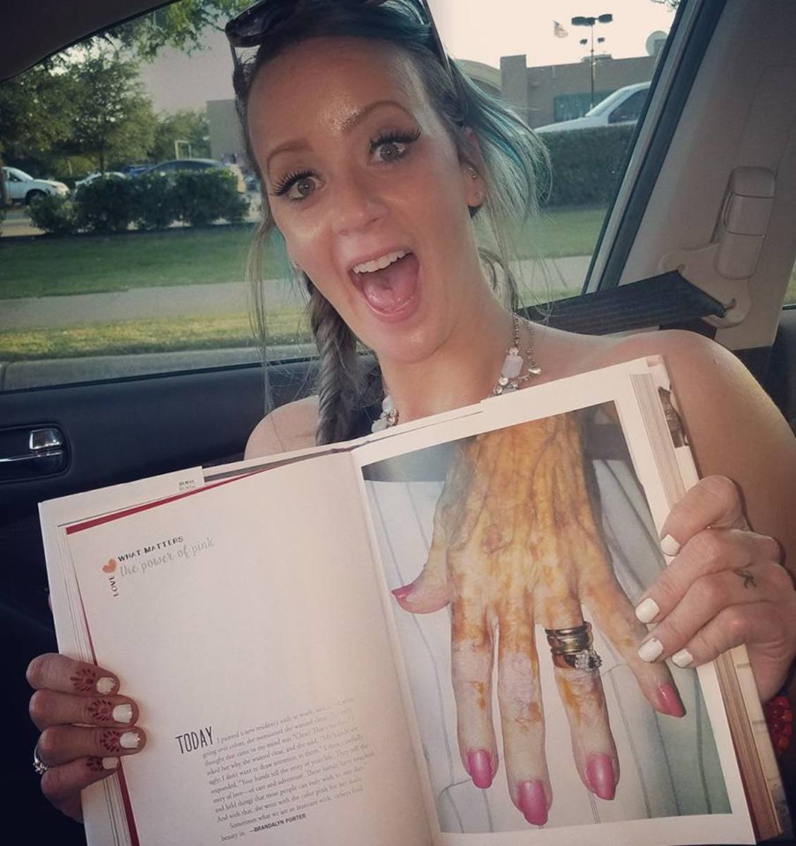 Brandalyn Mae Porter smiling while holding a book open to a page of a close-up of an elderly woman's hand, Photo Credit: Brandalyn Mae Porter/Facebook