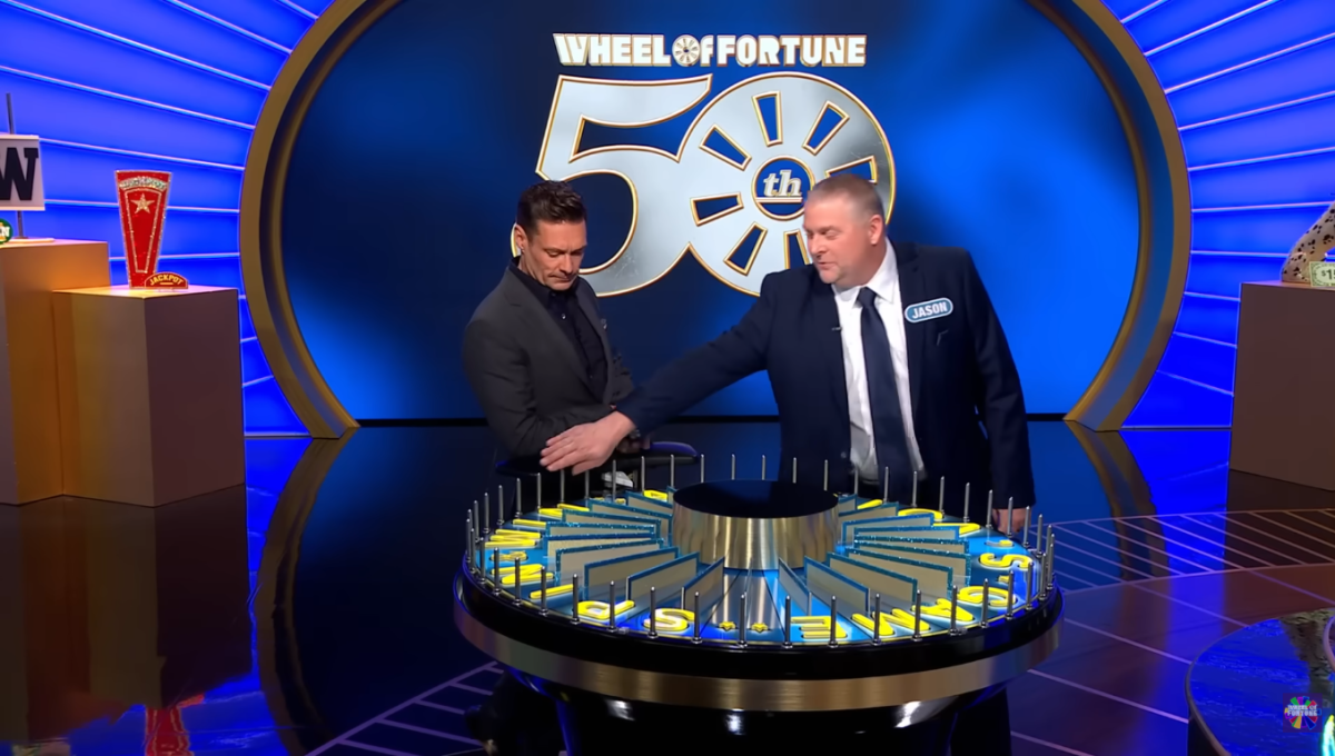 Contestant Jason Blackwell spinning the wheel with host Ryan Seacrest, Photo Credit: Wheel Of Fortune/Youtube