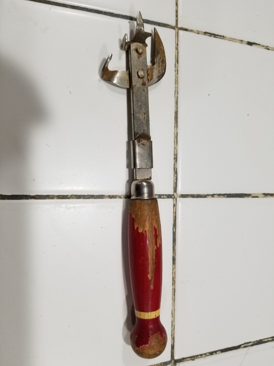 A vintage can opener laying on a tiled surface, Photo Credit: Reddit