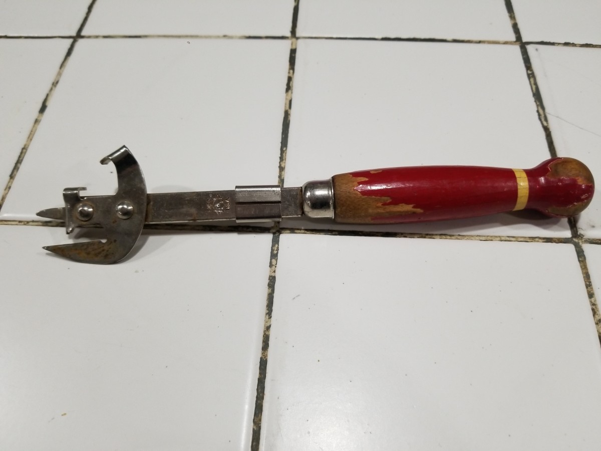 A vintage can opener laying on a tiled surface, Photo Credit: Reddit