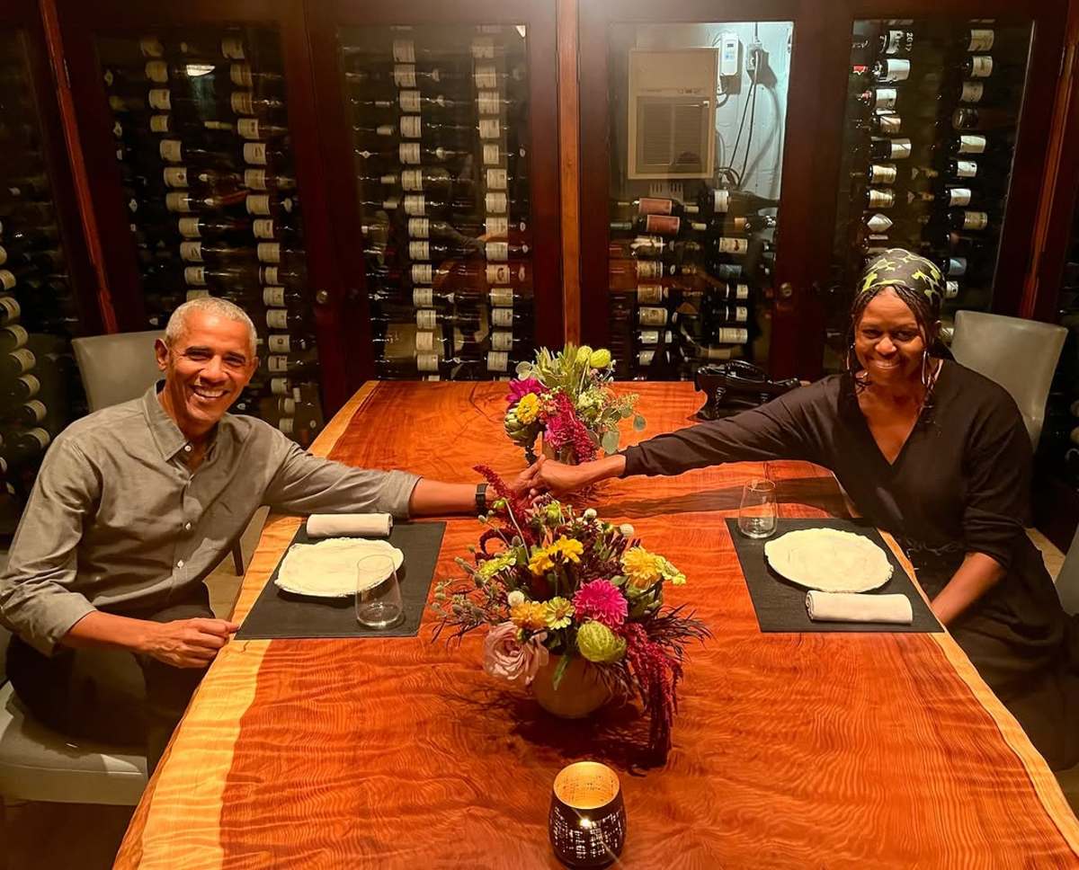 President Obama holding hands with Michelle across the dinner table, Photo Credit: barackobama/Instagram