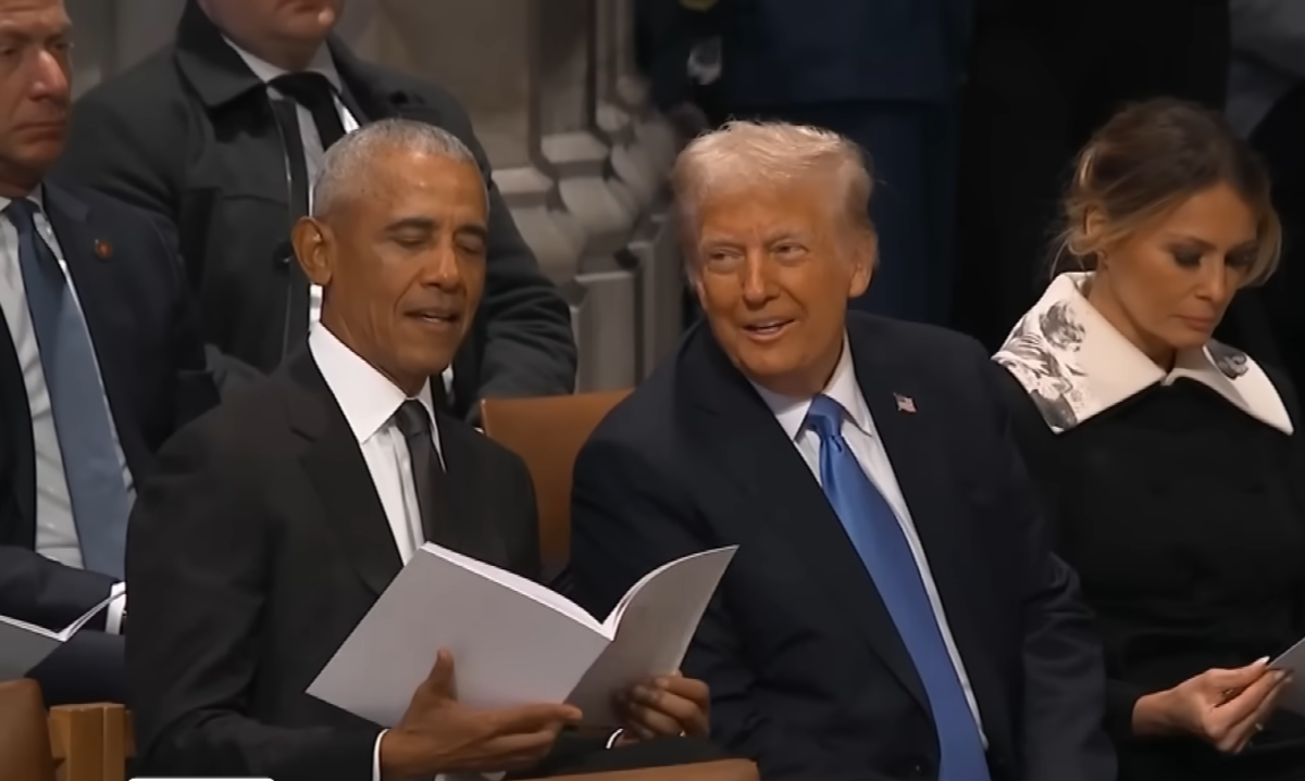 President Trump cracking a smile while speaking to President Obama at Jimmy Carter's funeral, Photo Credit: Inside Edition/Youtube