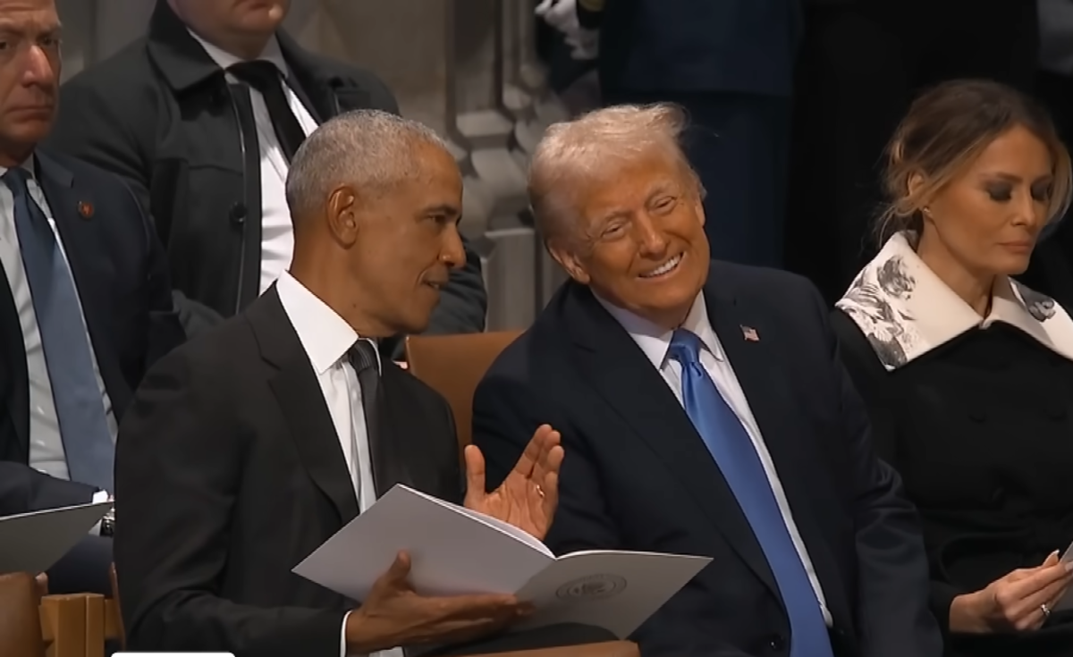 President Trump cracking a smile while speaking to President Obama at Jimmy Carter's funeral, Photo Credit: Inside Edition/Youtube