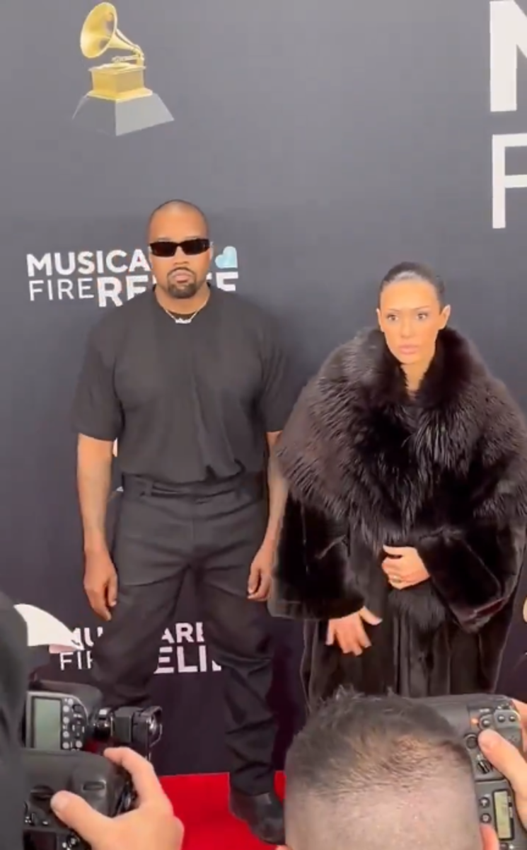 Kanye West and Bianca Censori wearing a coat on the Grammys red carpet, Photo Credit: Peter Lloyd/X