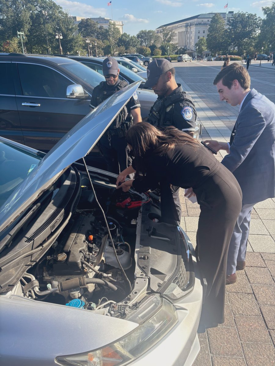 Alexandria Ocasio-Cortez looks under the hood of a stranded motorist's car; Photo Credit: mike casca/X