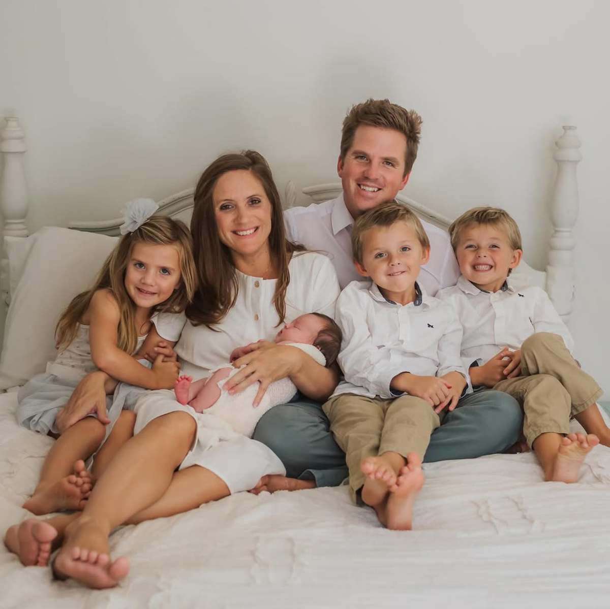 Desiree and Ryan Fortin sitting with their triplets and a newborn, Photo Credit: theperfectmom/Instagram