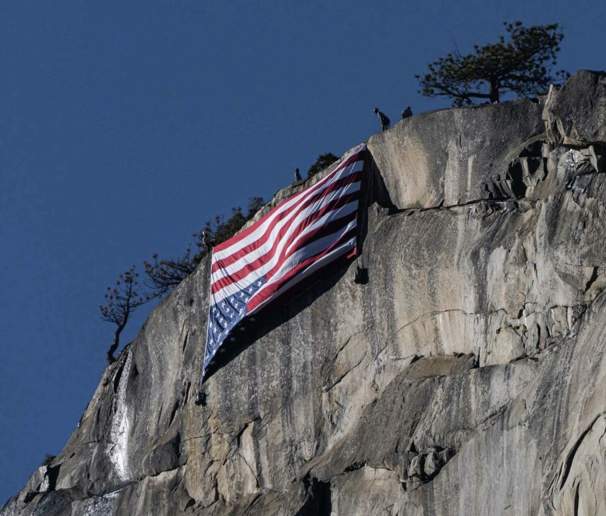 American flag hung upside-down from a cliff face on Yosemire National Park, Photo Credit: CBS47 KSEE24/Youtube