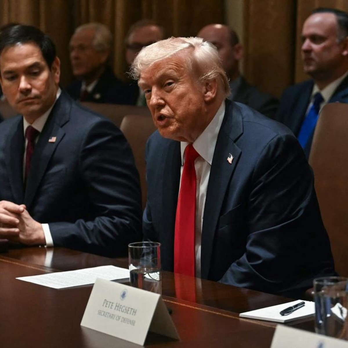 President Donald Trump sitting at a table in a meeting, Photo Credit: realdonaldtrump/Instagram