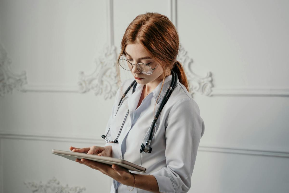 A Doctor Wearing Eyeglasses Using a Tablet, Photo Credit: Pexels