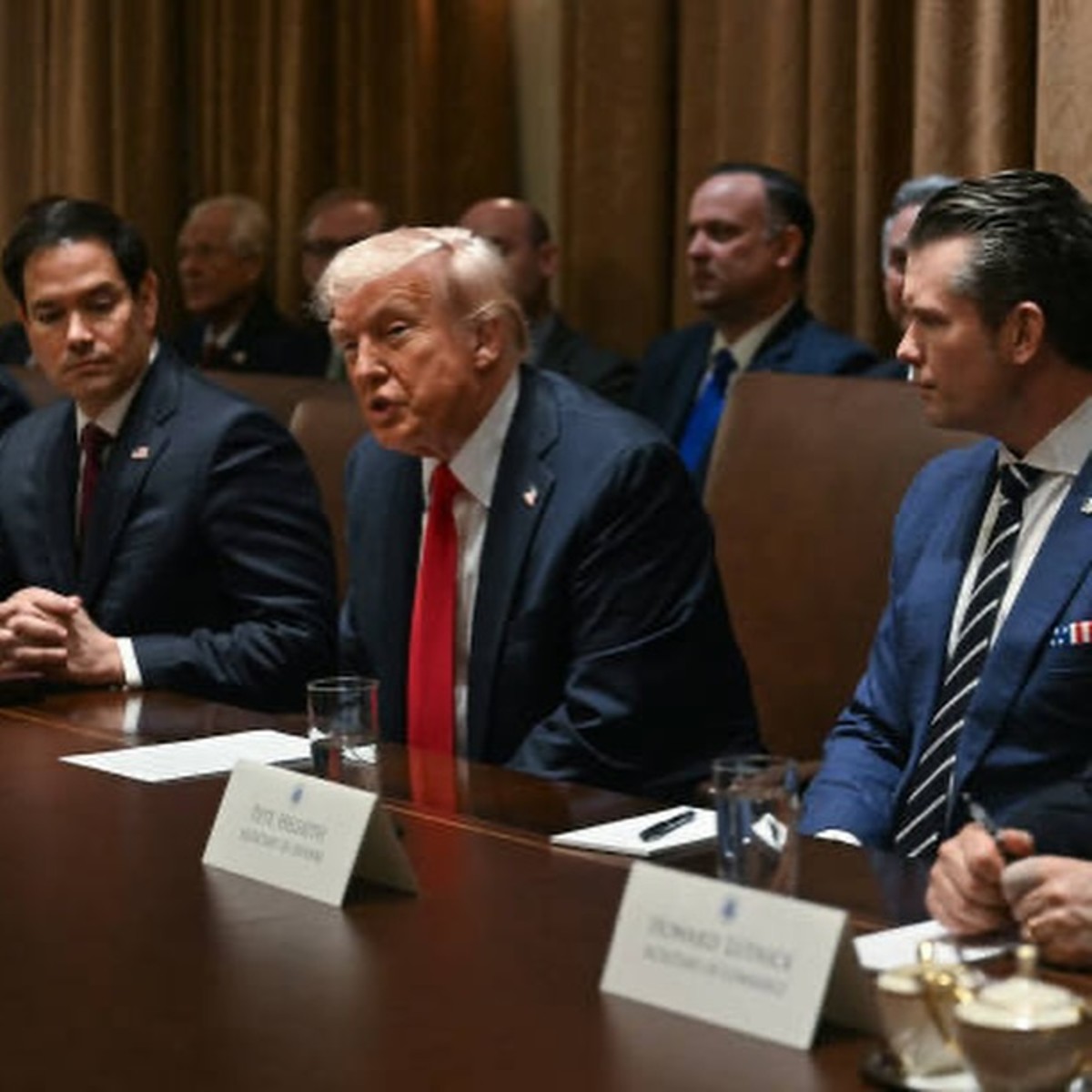 President Donald Trump sitting at a table in a meeting, Photo Credit: realdonaldtrump/Instagram