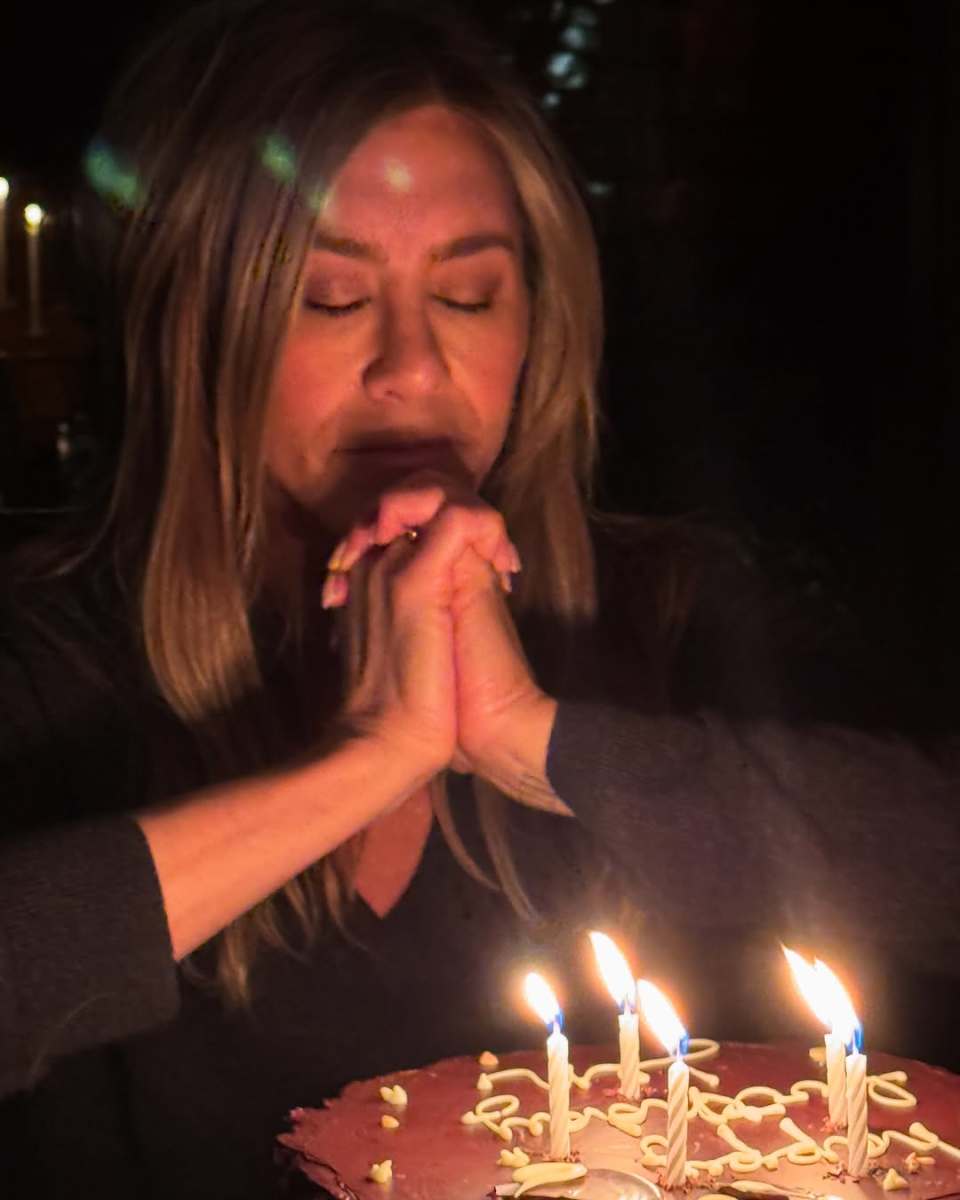 Jennifer Aniston making a wish in front of a birthday cake, Photo Credit: jenniferaniston/Instagram