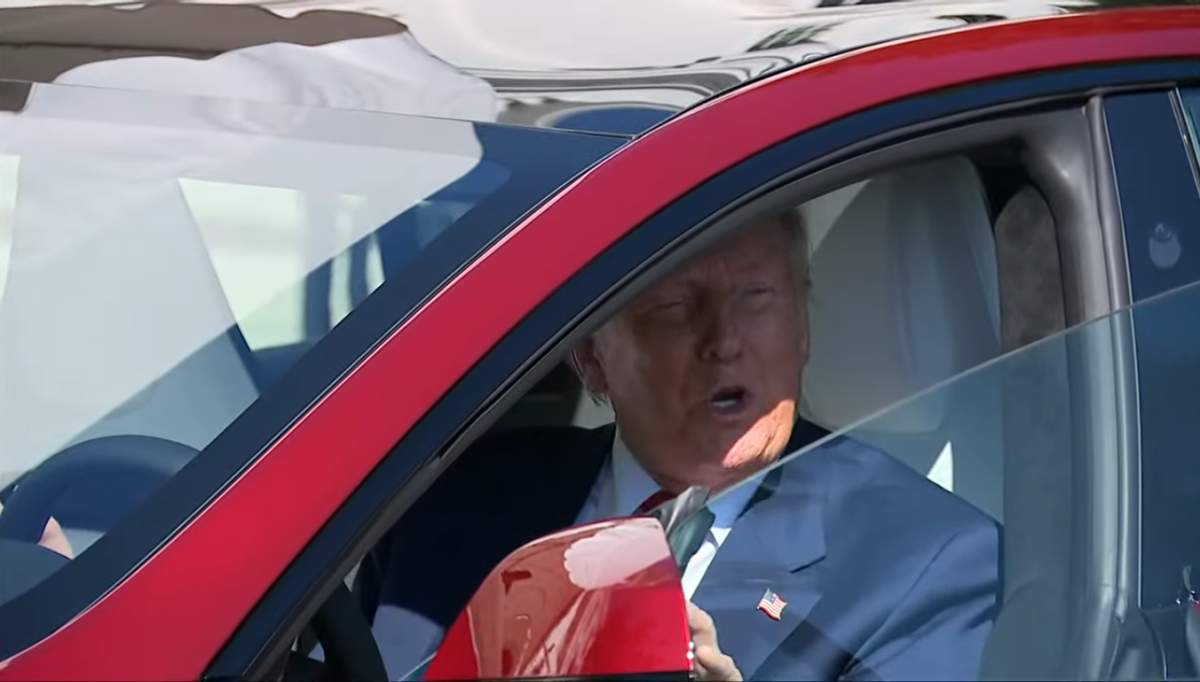 President Trump speaking to reporters while inside a red Tesla, Photo Credit: Fox News/Youtube